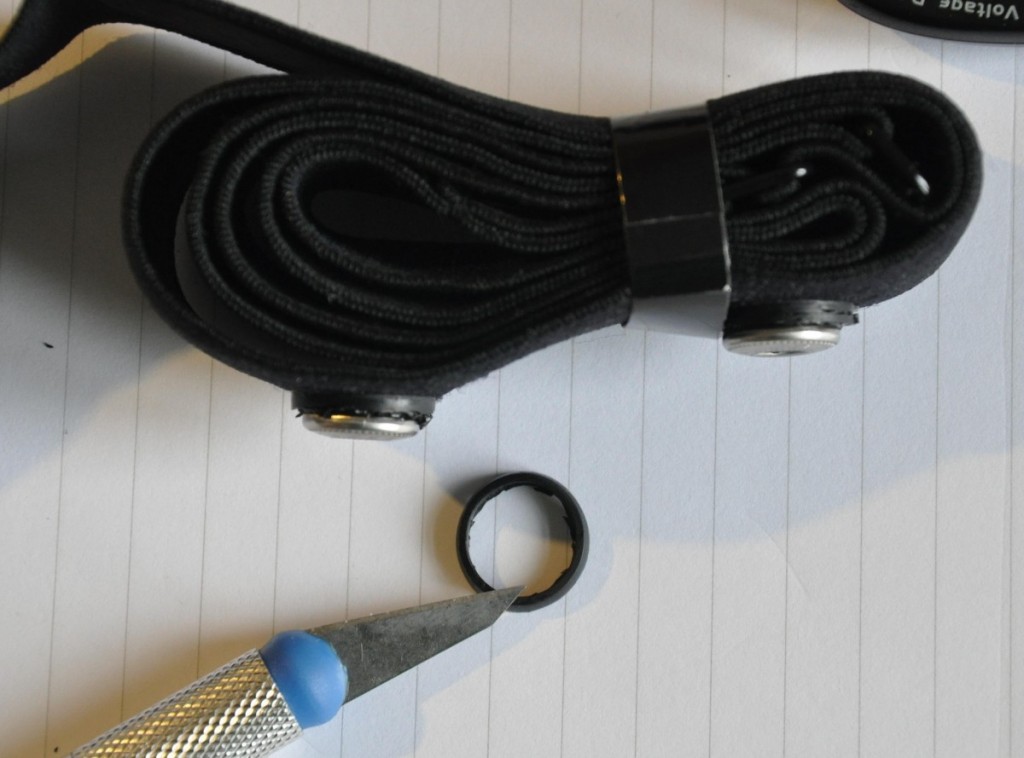 Closeup showing strap after removing the rubber surround